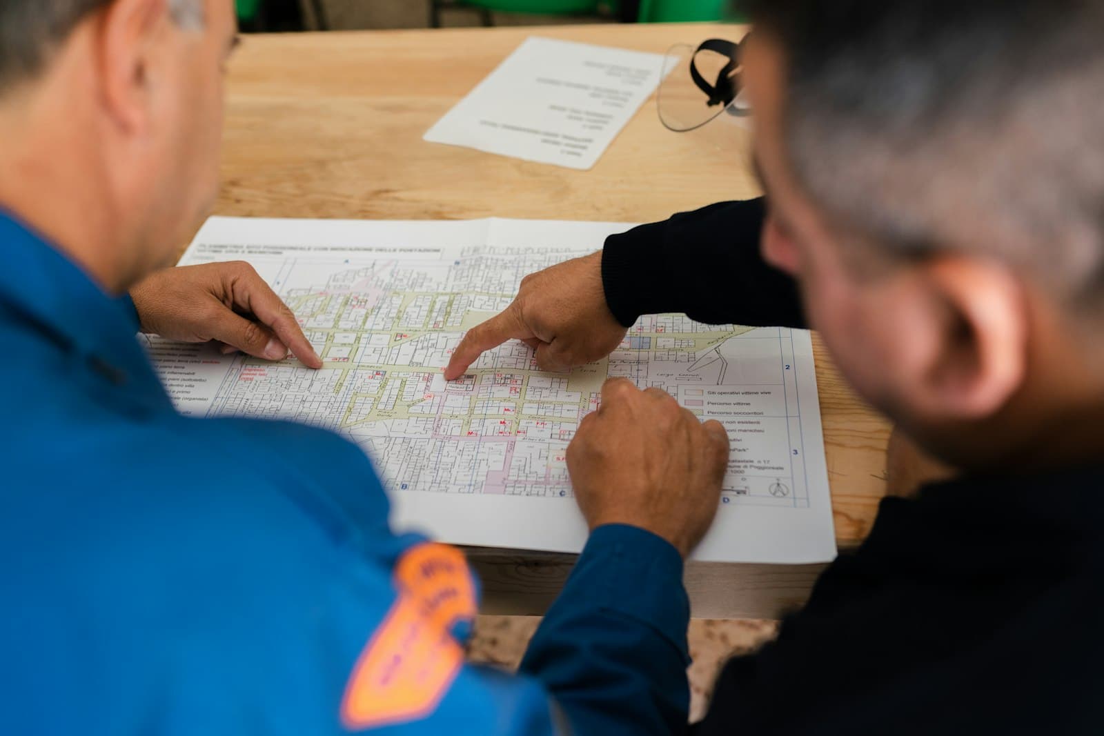 Two engineers reviewing technical drawings